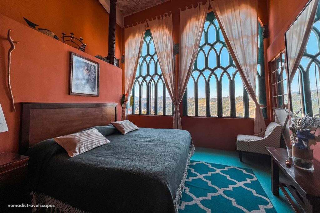 Edward James' Bedroom with terra cotta walls and vintage antiques in Posada El Castillo in Xilitla México