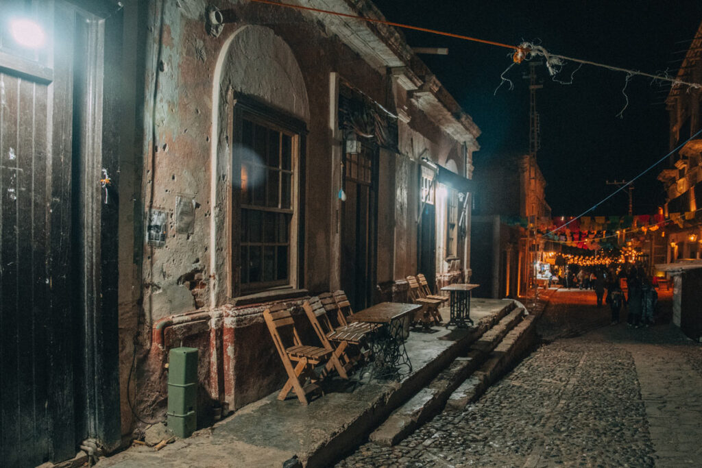 Nightime view of an alleyway in real de catorce with stores closed.