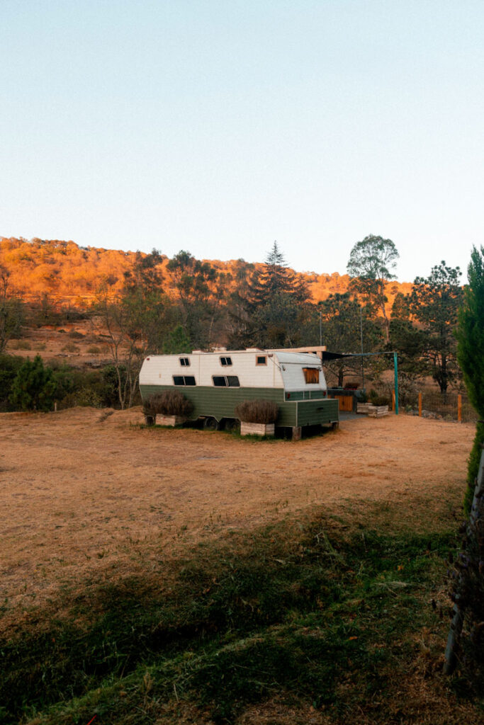 White & Green Campervan Airbnb at La Comuna in the golden light