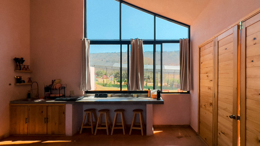 Private Kitchen of Casa Rosa Airbnb in Amealco de Bonfil, overlooking a large window.