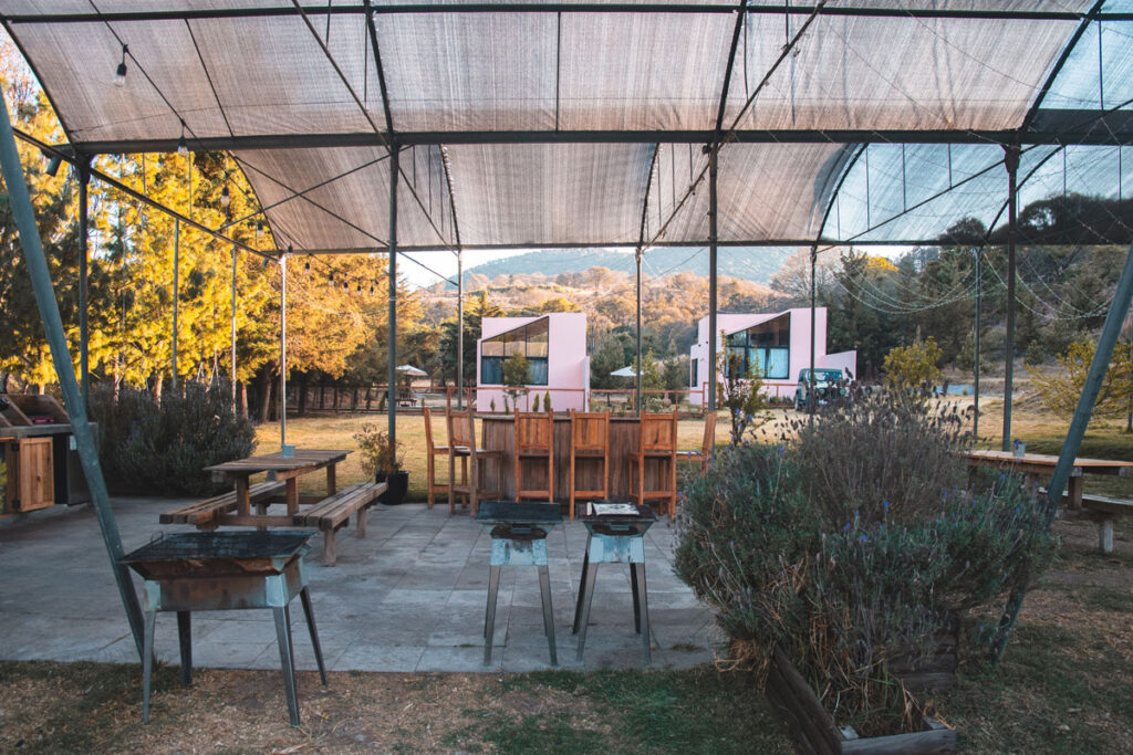 Shared Kitchen with chairs, charcoal bbq, views of Pink Cabins of La Comuna Amealco de Bonfil