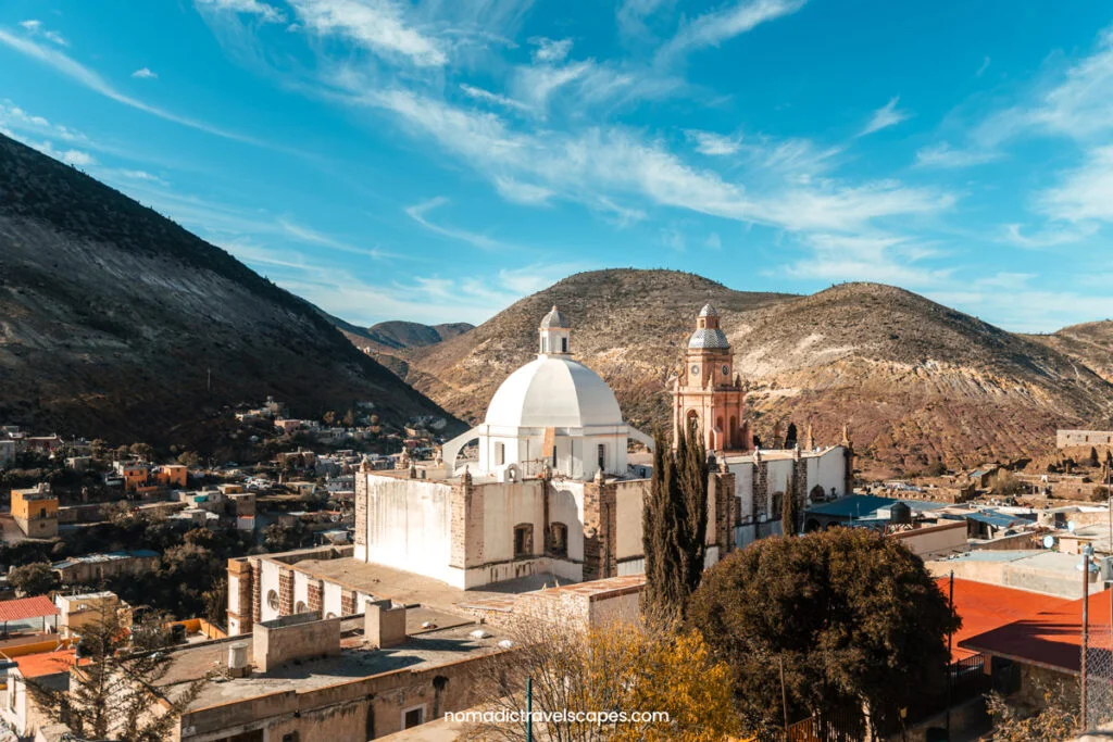 View of Iglesia Real de Catorce on a sunny day with blue skies, taken from the rooftop of a hotel